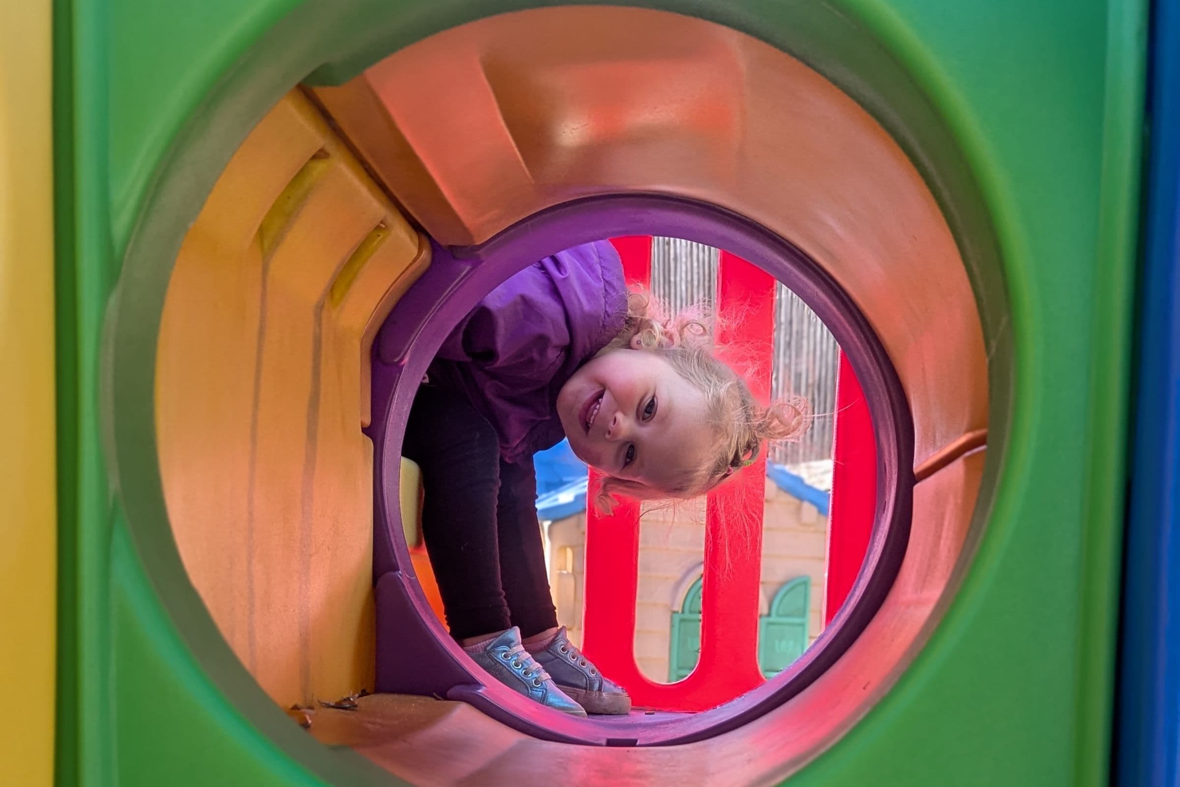 Child playing on the playground at Apples & Books Learning Center