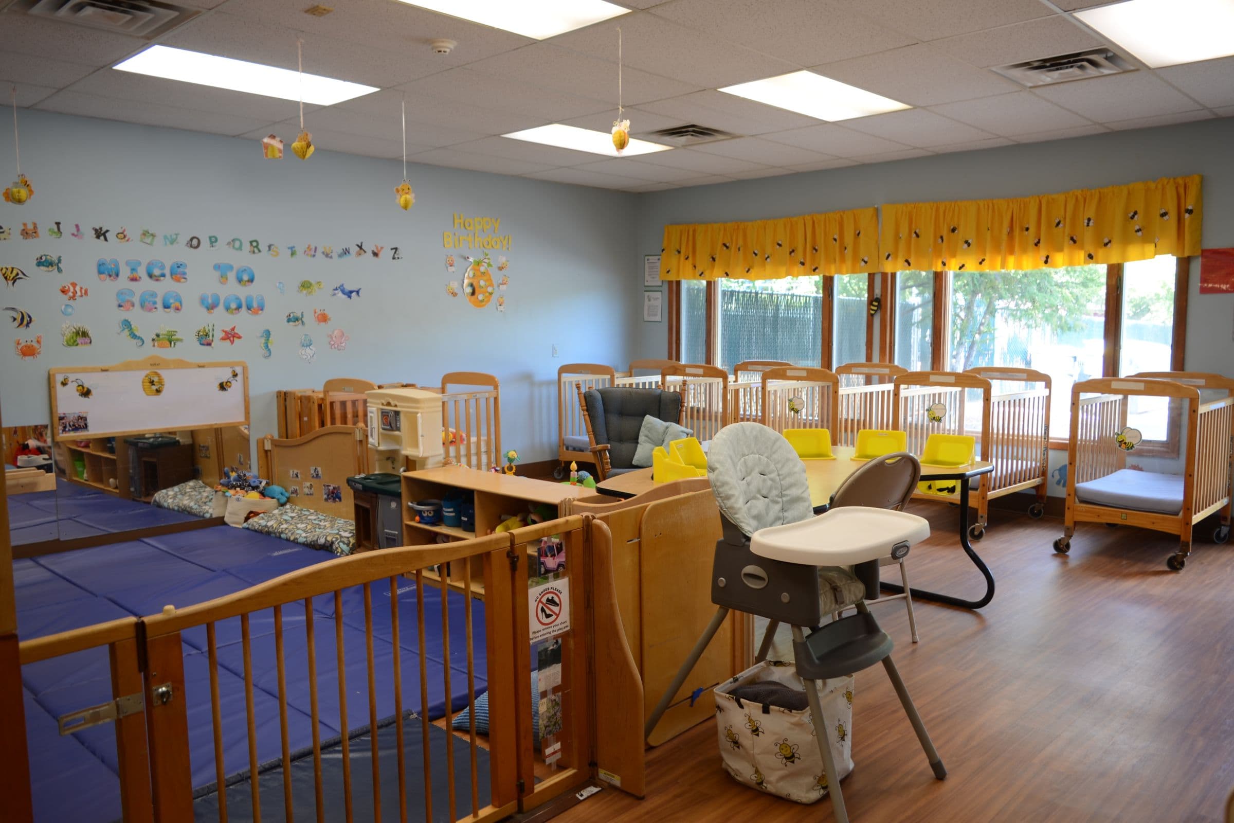 Toddlers and teachers in a bright classroom at Apples & Books Learning Center